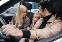 Road-Trip Ready: 6 Cabin-Comfort Upgrades That Make Long-Haul Driving Less Exhausting Family sitting inside a car and smiling together during a drive, representing a quieter and more comfortable cabin experience with automotive sound deadening materia