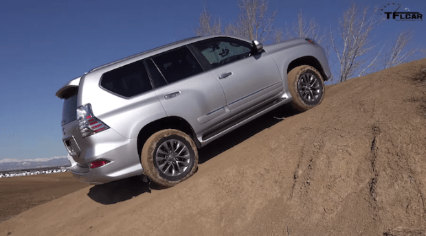 2015 lexus gx460 is climbing a steep and muddy hill