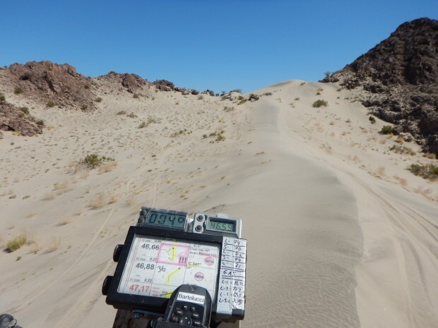 A motorcycle prepares to climb a dune in the 2015 Cortez Rally.
